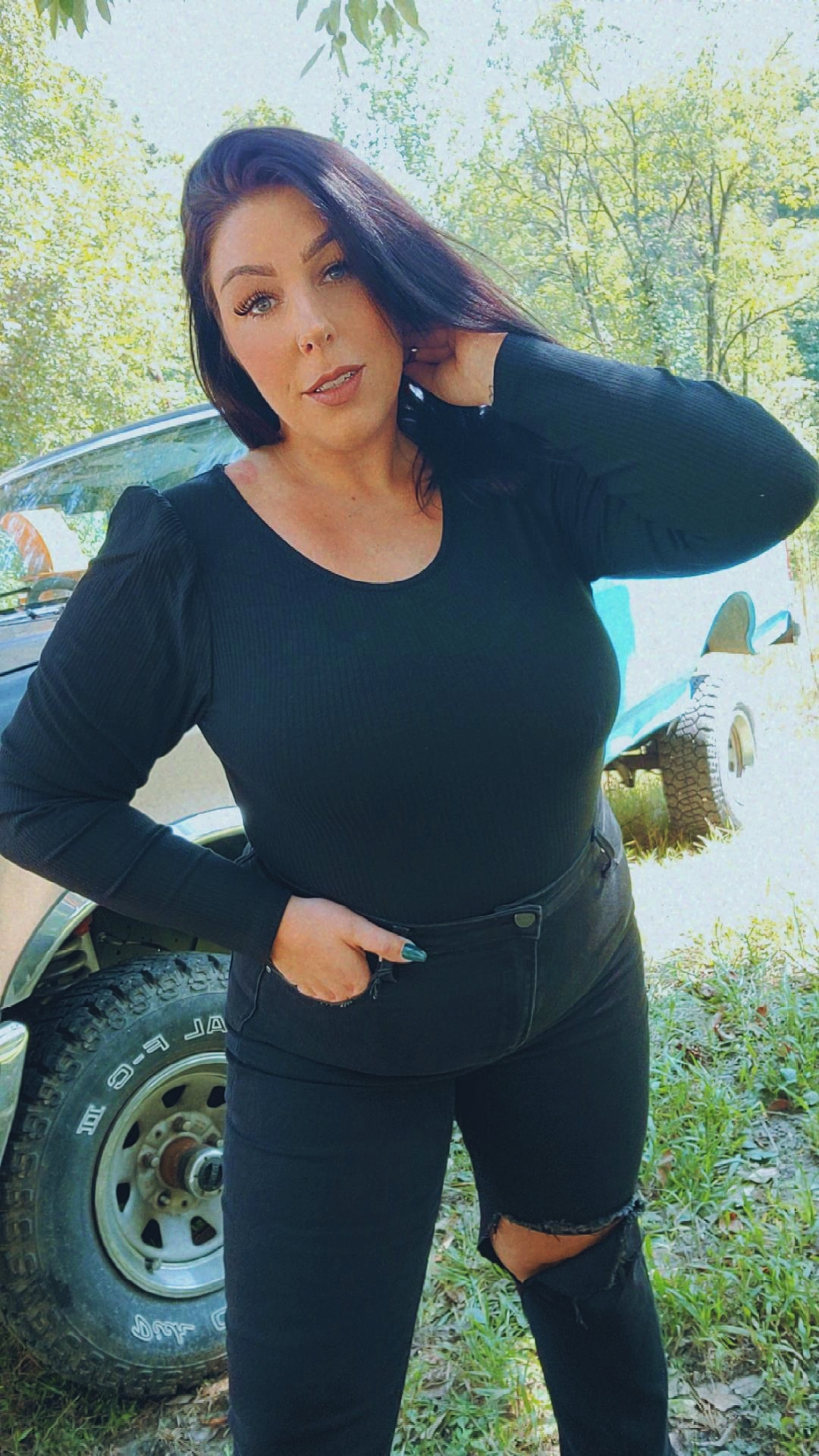 Black long sleeve body suit with an open back tie design.