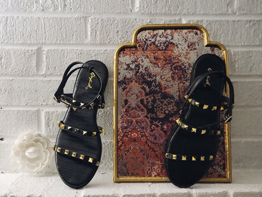 . Color Black  . A studded strapped sandal That is justable   around the ankle.  . True to size stay with your normal sizing.  .  Cute alligator detail.  . Felicia is wearing her normal size 8