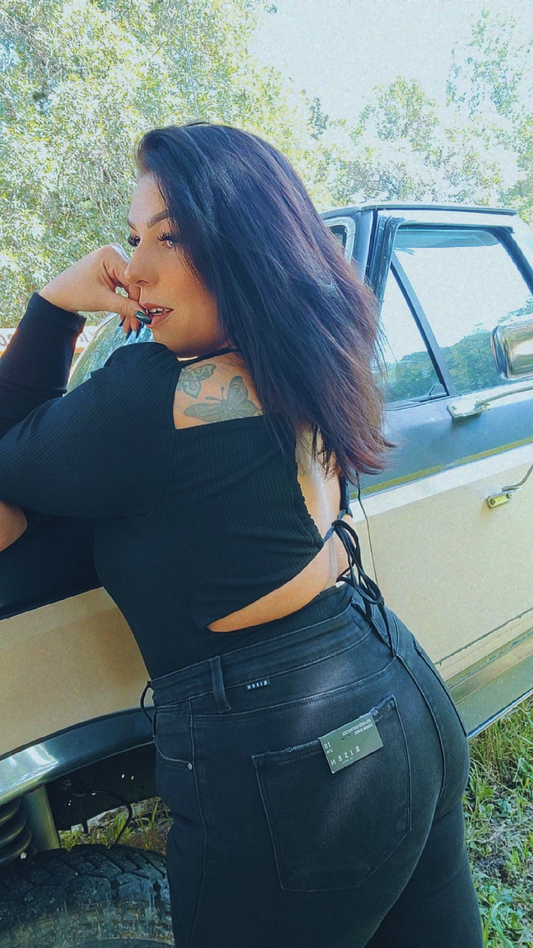 Black long sleeve body suit with an open back tie design.