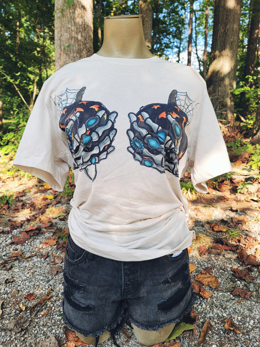 cream colored tee shirt with pumpkin skeleton hands