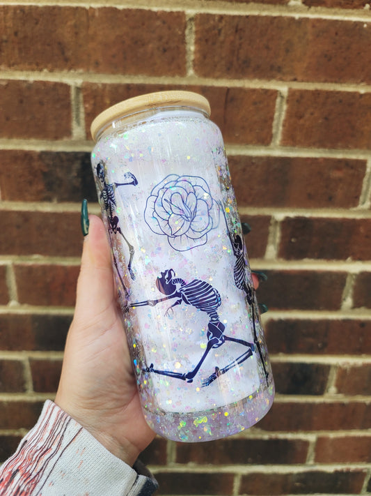 Dancing skeleton Snow Globe tumbler with shimmering light colored glitter. With bamboo lid and a straw.