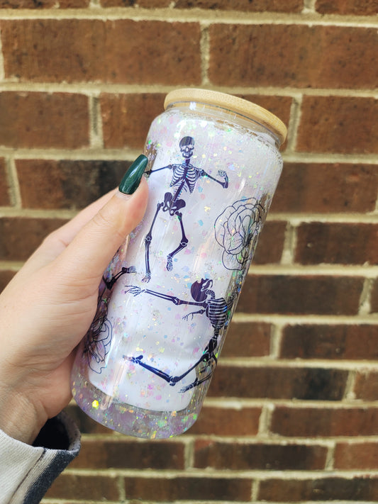 Dancing skeleton Snow Globe tumbler with shimmering light colored glitter. With bamboo lid and a straw.